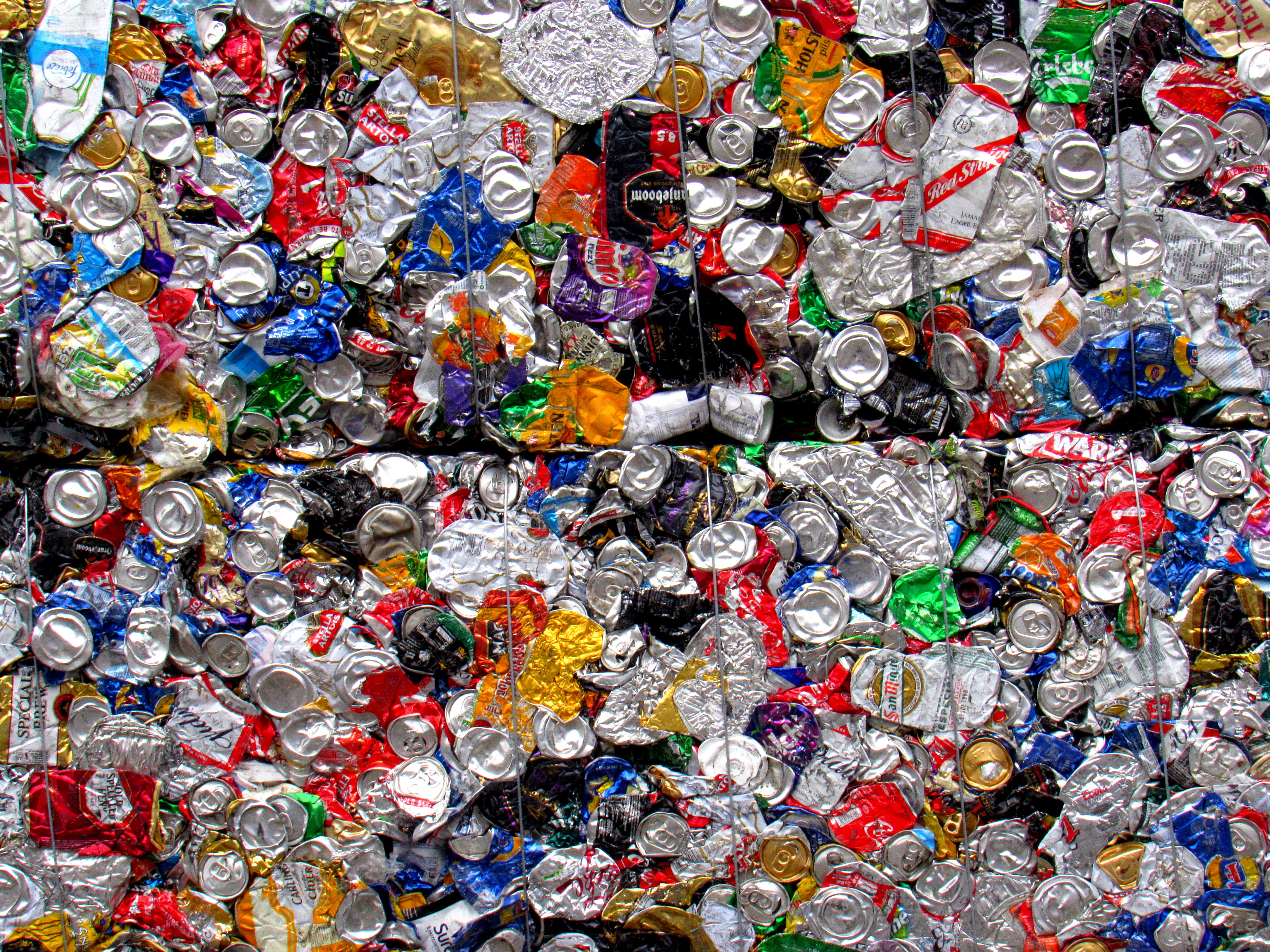Compressed bales of used aluminium beverage cans at a recycling facility