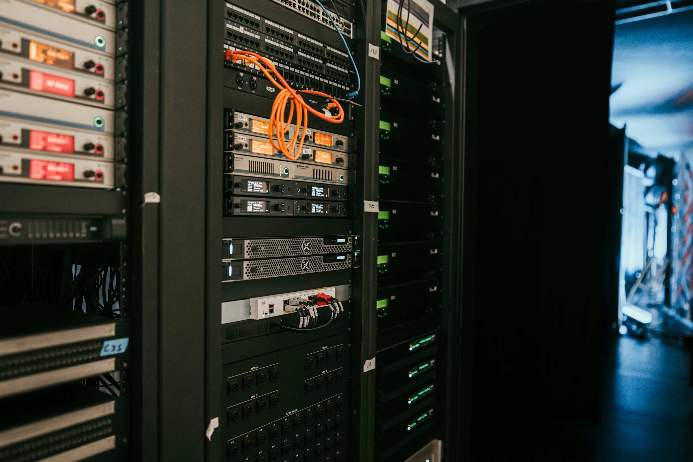 Dense server racks and network cabling inside a modern data centre