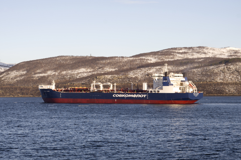 The Russian icebreaking oil tanker Mikhail Ulyanov underway near a snow-covered Arctic coast
